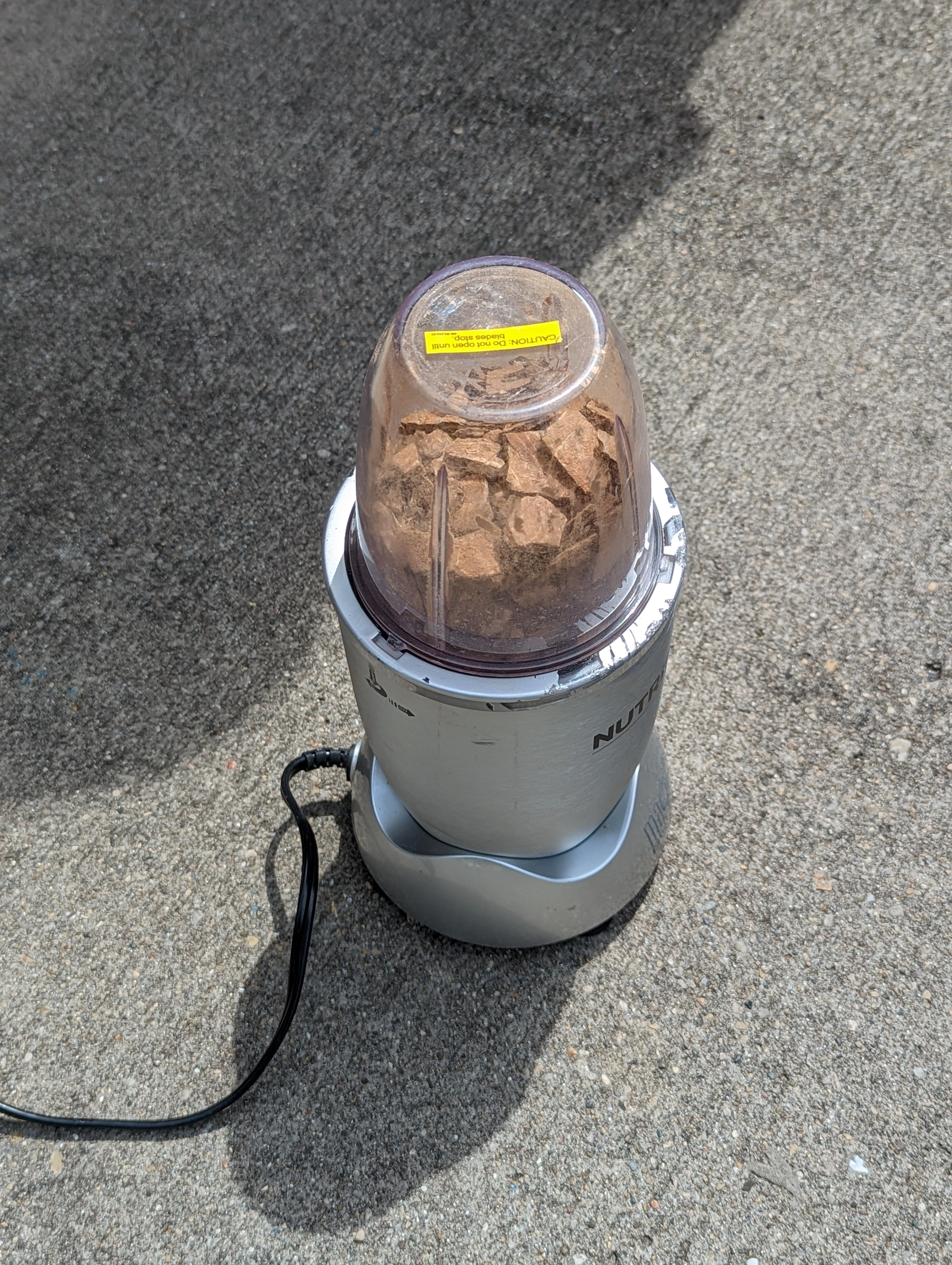 Coconut shell fragments being blended into material for brick prototyping.